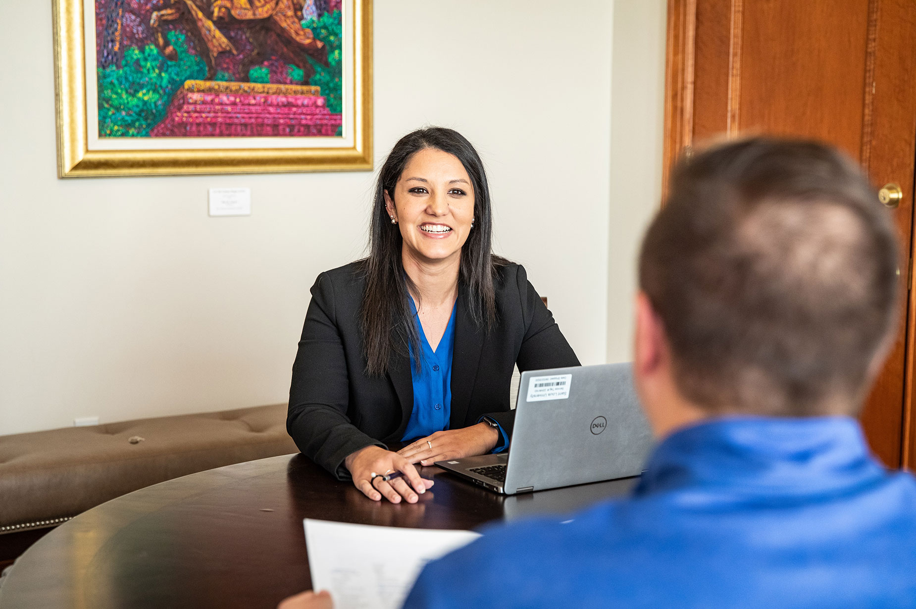 A SLU admission counselor meets with a student in an office setting