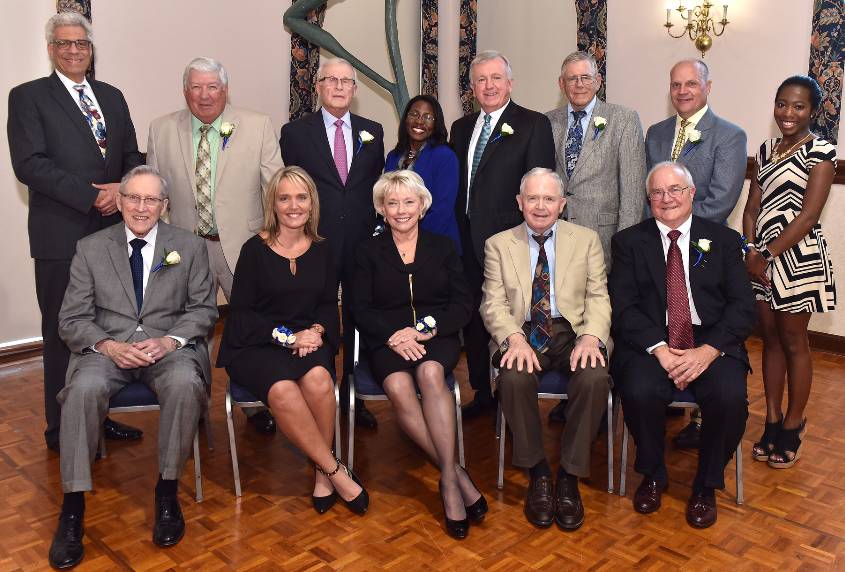 Alumni Merit Awardees 2017 A group of men and women pose for a photo inside.