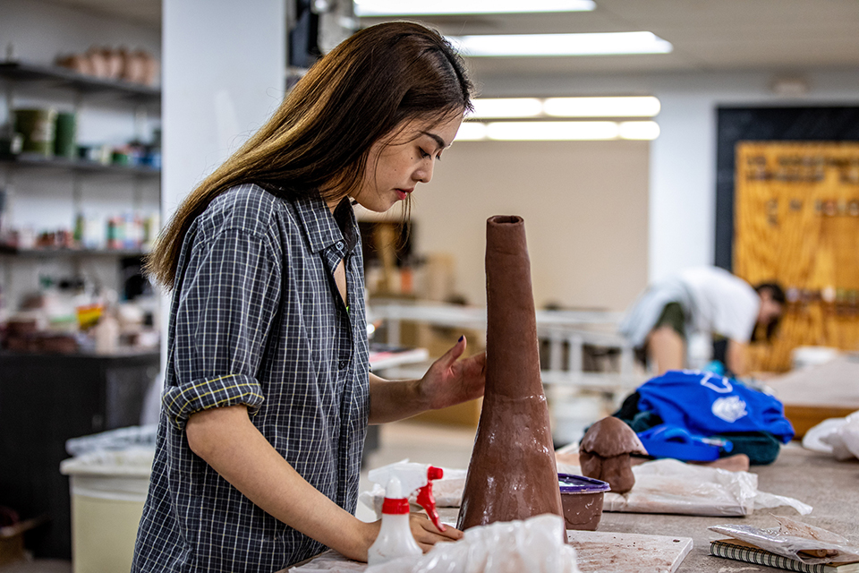SLU Studio Art Student A student works on a ceramic artwork