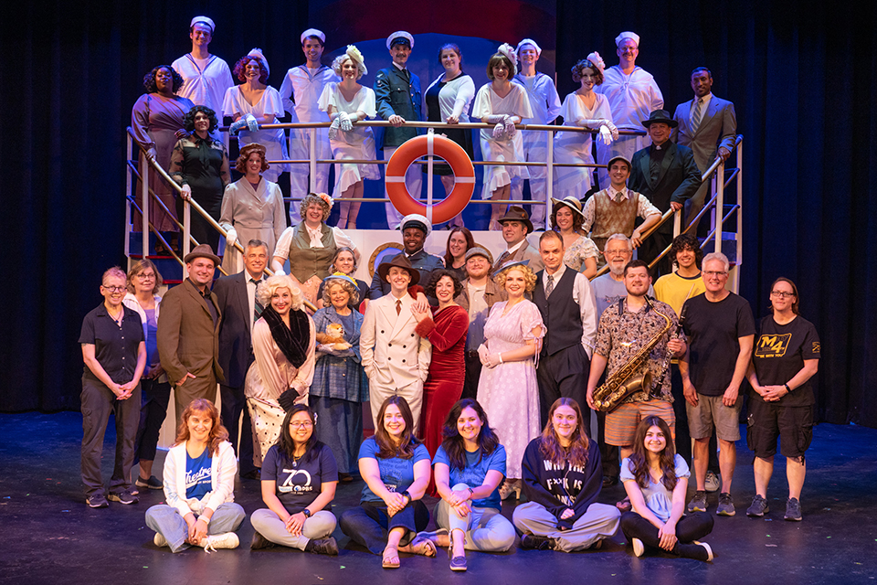 The Cast and Crew of Anything Goes A large group of people pose on a set ship