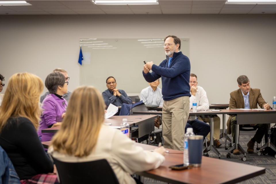 a man presenting in front of a group of people