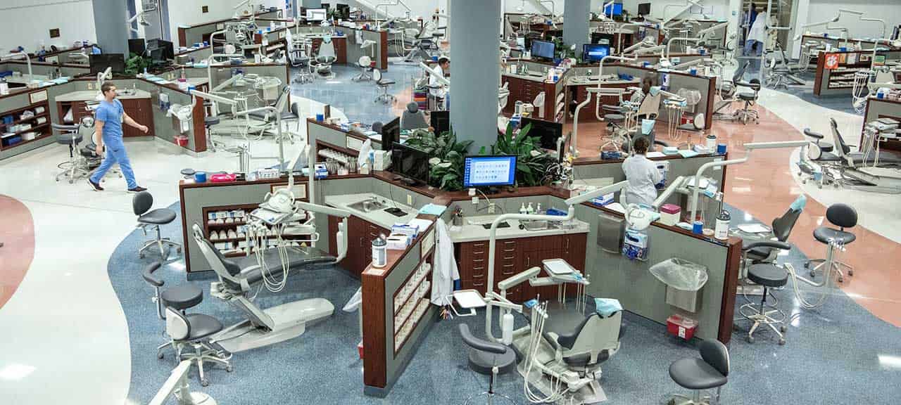 An aerial view of the CADE orthodontics floor, which houses multiple dental work stations that include dental chairs, lights and tool stations.