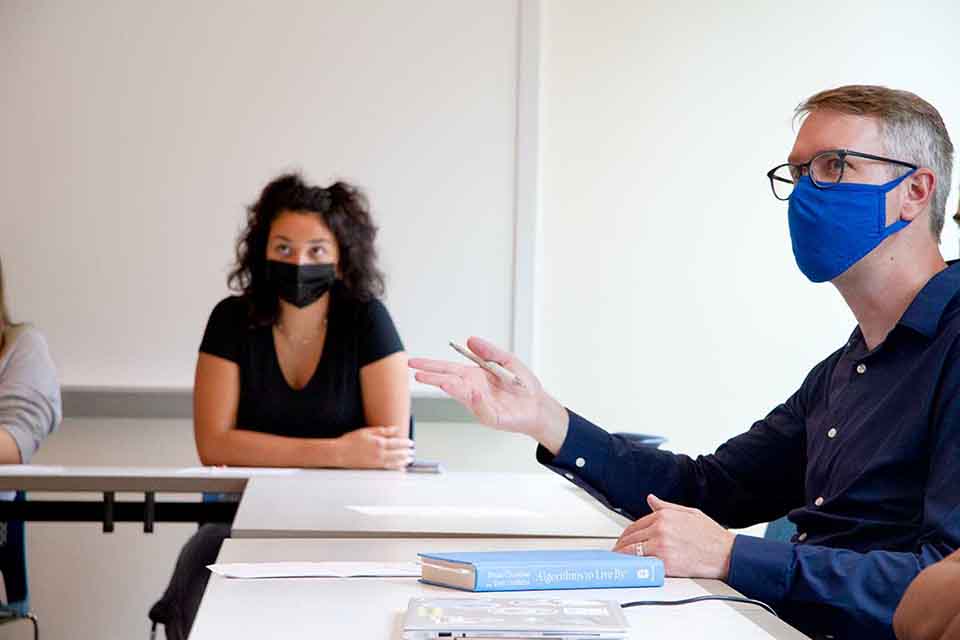 Classroom Two students in masks sitting at a classroom table