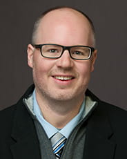 Justin Lacy wearing suit and tie