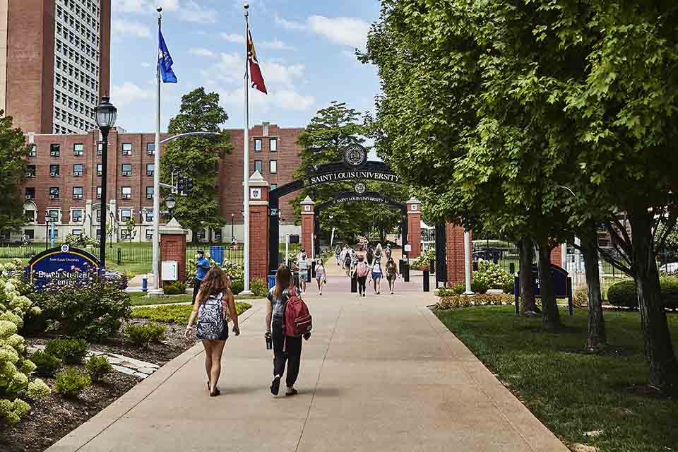 SLU gateway People walking through SLU's Grand Boulevard gateway on a summer day