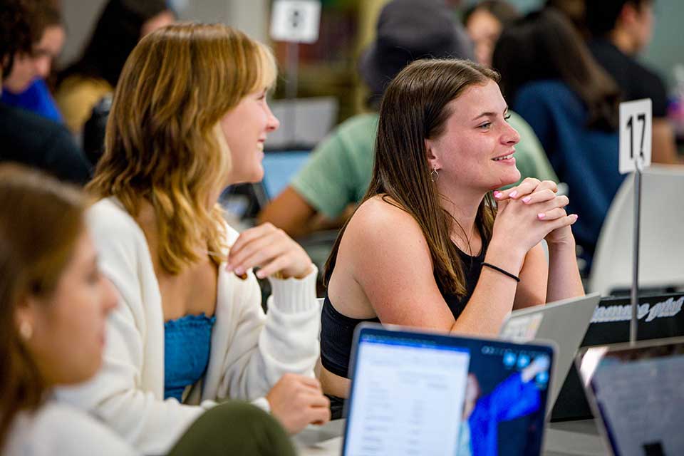 Interprofessional Education students listen to an instructor while sitting in a SLU classroom.