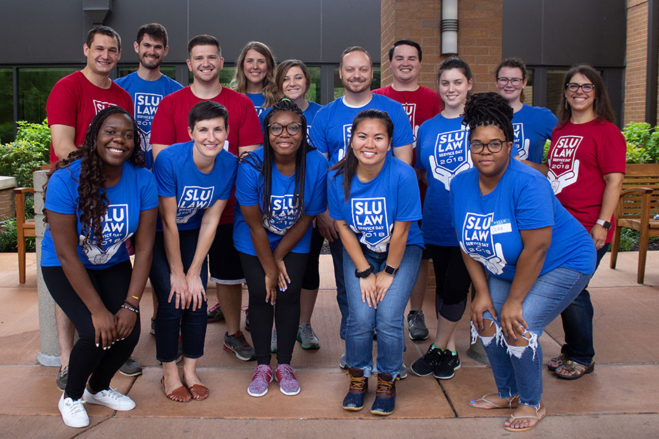 Students wearing SLU Law shirts pose for a photo as a group Orientation Service Day 2018