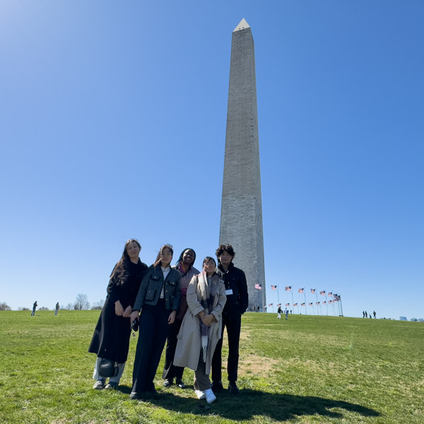 Fall 2024 DC Career Trek A group of students poses with the Washington Monument in the background.