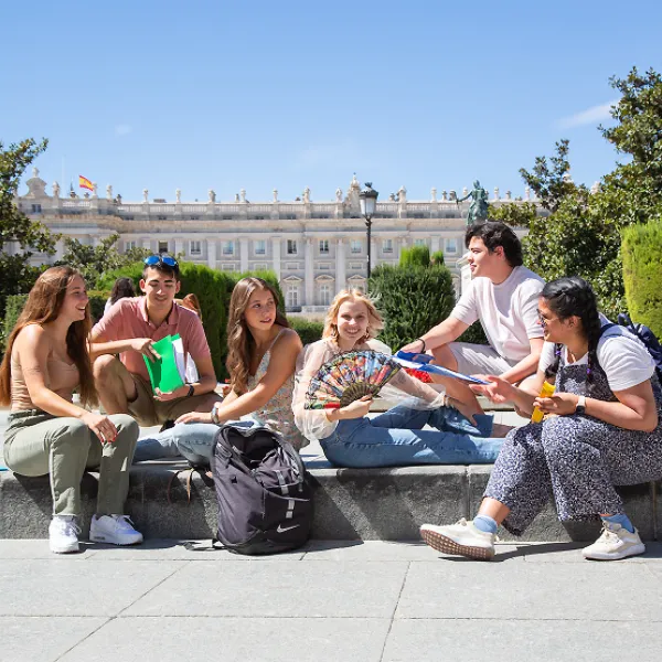 SLU students stand and mingle near the gateway of the SLU-Madrid campus.