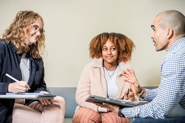 Two students work on their laptops at a desk in San Ignacio Hall, one of the university’s buildings.