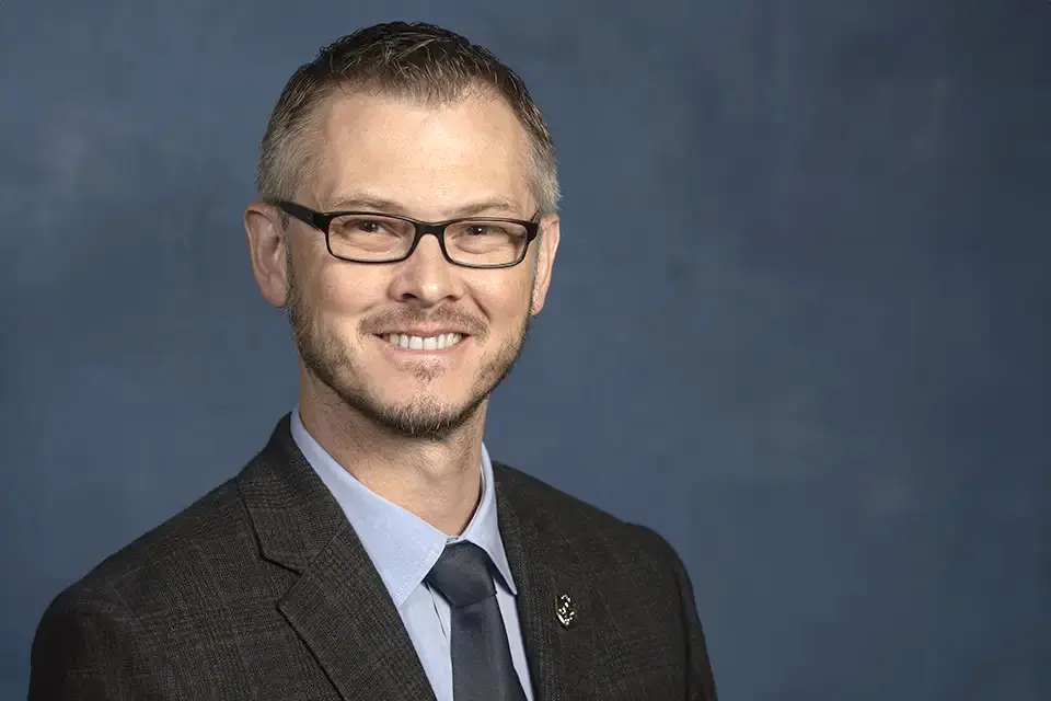 William Johnson, J.D. Headshot of William Johnson in a suit and tie.