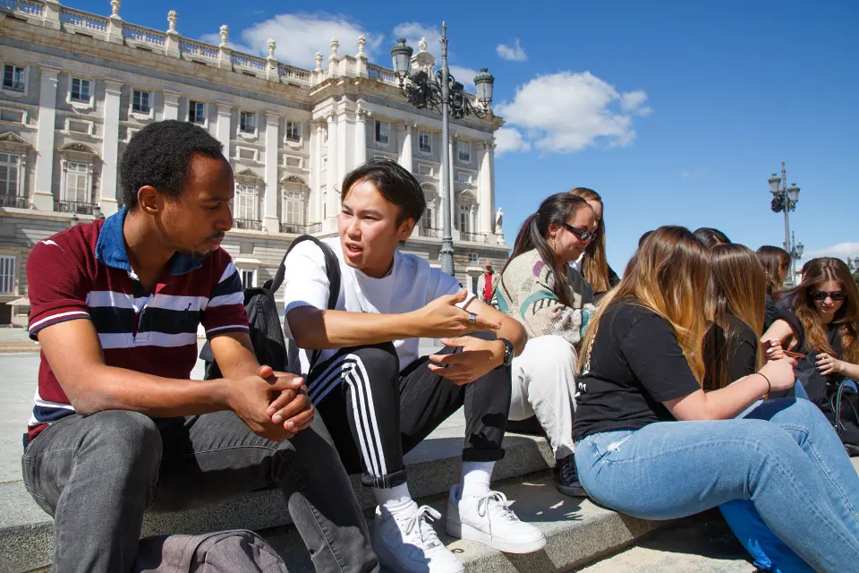 A group of students taking a selfie in the street.