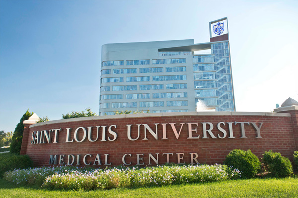 Exterior of Doisy Research Center behind a large sign that reads Saint Louis University Medical Center