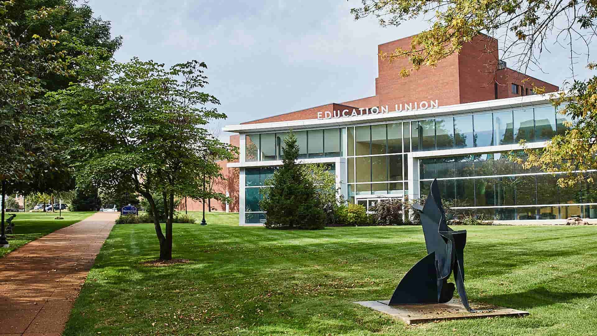 An exterior view of the glassed front of the Health Sciences Education Union on a sunny afternoon.