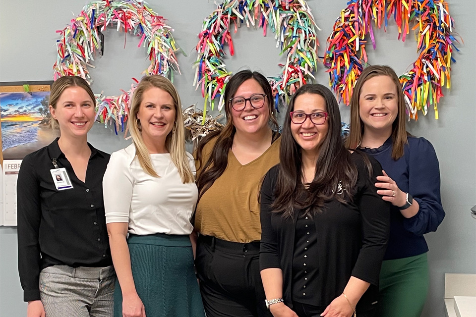 A group of fellows taking a group photo in front of a party background A group of fellows taking a group photo in front of a party background