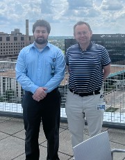 Robert Kousnetsov Robert Kousnetsov posing outdoors next to colleague