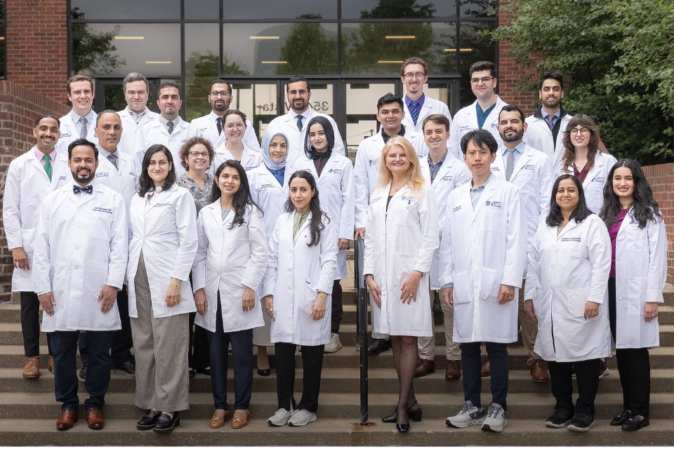 2025 Neurology Residents The group of 2025 neurology residents stand on stairs in front of a building for a group pic.