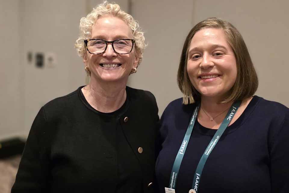 two women smile for a picture