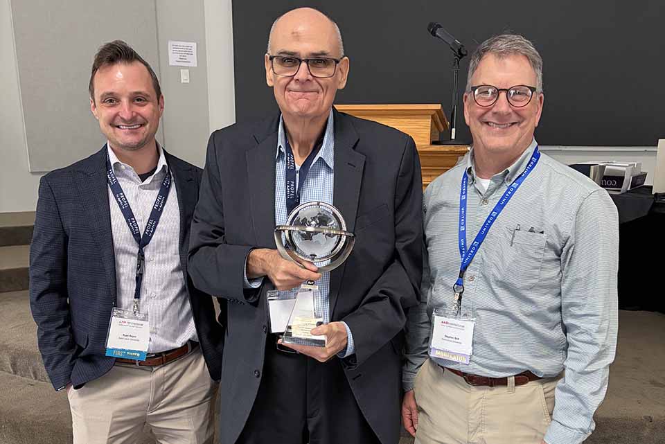 a group of men holding a trophy