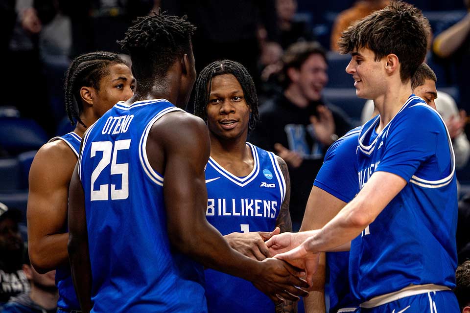 NCAA Postseason Members of the SLU Men's Basketball team congratulate each other following a win in the first round of the NCAA Championship