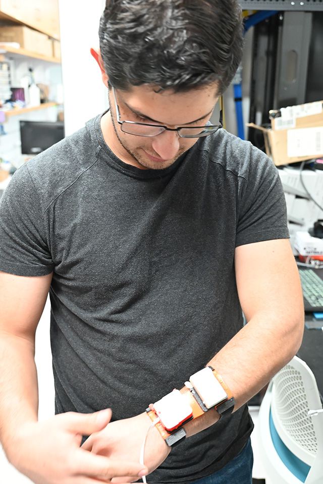 Nicolas Prudencio adjusts the wearable haptic device. Nicolas Prudencio adjusts the wearable haptic device.