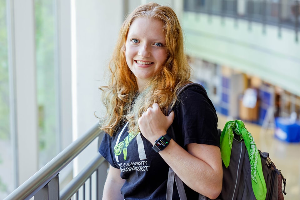 Allison Twohig Green Bandana Project SLU student Allison Twohig poses with a backpack and green bandana